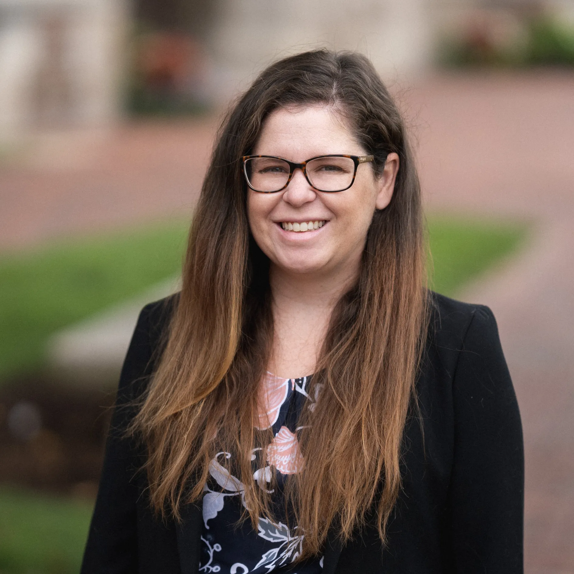 Photo of Meg in a black jacket in the Quad at WashU